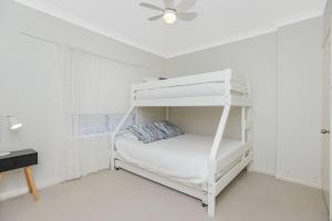 a white bunk bed in a white room with a ceiling at 15A Elliot - BYO Linen - Wi-Fi - Close to Beach in Hayborough
