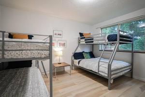 a bedroom with two bunk beds and a window at Poulsbo Scandinavian Retreat 2 blocks to DT in Poulsbo