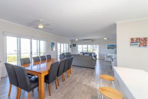 a dining room and living room with a table and chairs at 16 Chapman Rd - BYO Linen - Pets Negotiable - Wi-Fi in Middleton