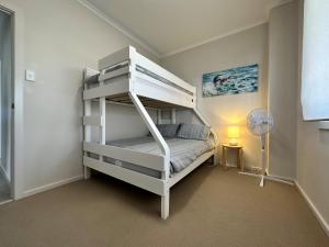 a white bunk bed in a room with a fan at 16 Chapman Rd - BYO Linen - Pets Negotiable - Wi-Fi in Middleton