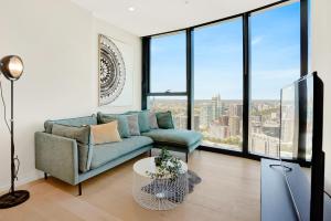 a living room with a couch and large windows at 3BR 2BATH, Southbank, Crown, Seaview, Level 41 in Melbourne