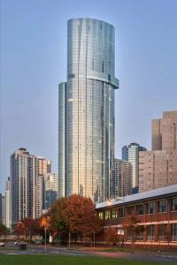 a tall glass building in front of a city at 3BR 2BATH, Southbank, Crown, Seaview, Level 41 in Melbourne