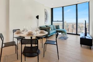 a living room with a table and chairs and a couch at 3BR 2BATH, Southbank, Crown, Seaview, Level 41 in Melbourne