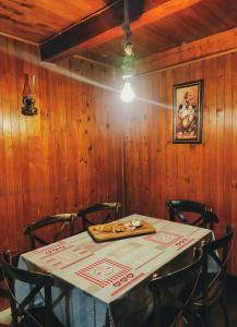 a table in a wooden room with a tableablish at Holiday Home Ljuban in Risovac