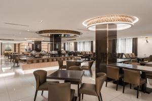 Hotel Yoshi في كاوشيونغ: مطعم بطاولات وكراسي وبار