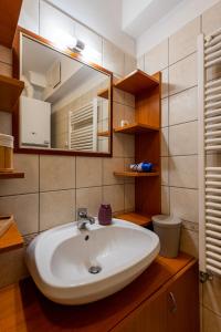a bathroom with a sink and a mirror at Pesti City Apartment&Free parking in Budapest +31 photos