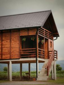 a large wooden house with a staircase leading to it at Etno Kutak Purtić in Ljubovija