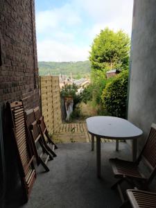 a table and chairs on a patio with a view at Le Nid Normand avec Terrasse - Stationnement facile et Gratuit - 5 min Seine in Déville-lès-Rouen