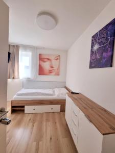a bedroom with a bed and a painting on the wall at RingRooms in Knittelfeld