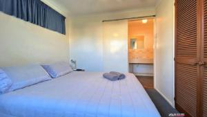 a bedroom with a large white bed in a room at Ocean Views in Burrum Heads