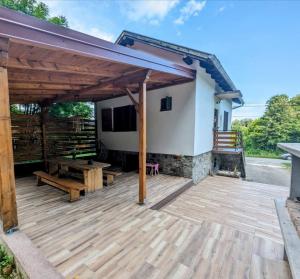 eine große Holzterrasse mit einem Pavillon in der Unterkunft Holiday home Tilia in Slatinski Drenovac