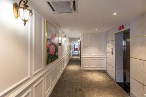 a hallway of a building with a painting on the wall at Frazel Heritage Hotel in Alor Setar +63 photos