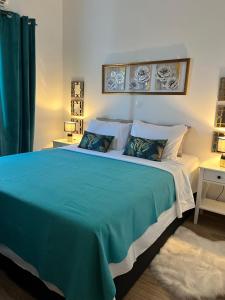 a bedroom with a large bed with a blue blanket at «Έλα…Δάρα» Home in Daras