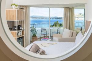 a room with a bed and a view of the ocean at INNSiDE by Meliá Ibiza Beach in San Antonio Bay