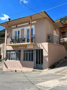 a large house with a balcony on a street at «Έλα…Δάρα» Home in Daras