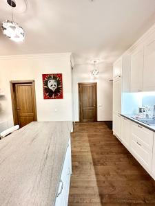 a kitchen with white cabinets and a counter top at New Town Classic Apartments SELF-CHECK IN in Vilnius