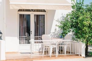 a patio with a table and chairs on a porch at Guest House Fjolla in Ulcinj