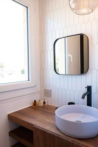 a bathroom with a sink and a mirror on the wall at Superbe studio avec balcon vue mer à 100m de la plage in Saint-Tropez