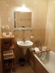 uma casa de banho com um lavatório e uma banheira e um lavatório em Apartman Classic em Komárno