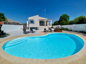 a large blue swimming pool in front of a house at Villa Elena - Private Villa in the heart of nature in Chania Town