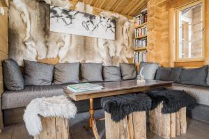 a living room with a couch and a table at Basecamp Oulanka in Ruka
