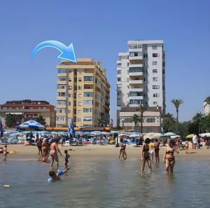 a group of people in the water at a beach at La Terrazza sul Mare in Montesilvano