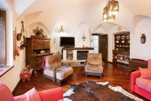 a living room with two chairs and a television at Bormio 3 in Bormio