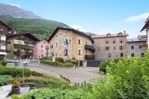 a group of buildings in a town with a mountain at Bormio 3 in Bormio