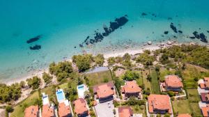 an aerial view of a beach with houses and the ocean at Possidi Villas in Possidi