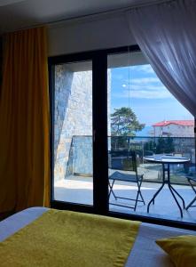 a bedroom with a large window with a view of a patio at MAV Boutique Villa in Eforie Nord