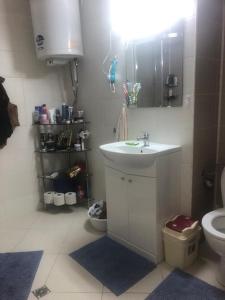 a bathroom with a sink and a toilet at Ravda Sun Sea Ressort 2 in Ravda