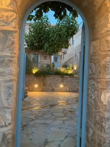 a view through an archway into a courtyard at Kranidi House. in Kranidi