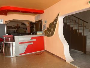 a kitchen with a counter and stairs in a room at Апарт Хотел Мари in Ravda