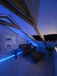 a living room with a couch and blue lighting at Sky apartment, Island Rab in Rab