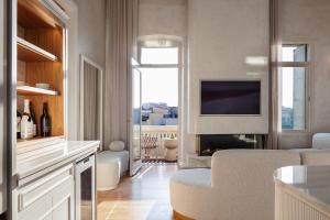 a living room with a television and a living room with a couch at La Torre Residenza Imperiale in Chania