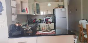 a kitchen with a black counter top and a refrigerator at LA vista topaz in Ain Sokhna