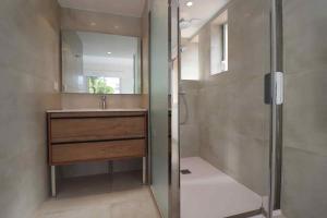 a bathroom with a sink and a shower with a mirror at Le Loup de Mer in Argelès-sur-Mer