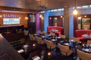 a restaurant with tables and chairs and a bar at Malmaison London in London