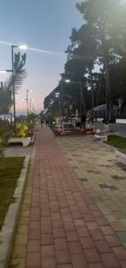 a sidewalk in a park with trees and street lights at Гостевой дом при кафе оазис in Kobuleti