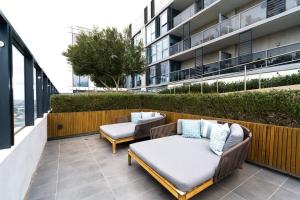 a patio with two couches on a building at Modern 1 Bed Opposite Racecourse in Melbourne