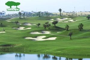 a golf course with a bunch of greens and water at Blue house 1ª linea playa in Torrevieja