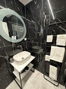 a bathroom with a sink and a mirror at Mora Houses in Mandrakia