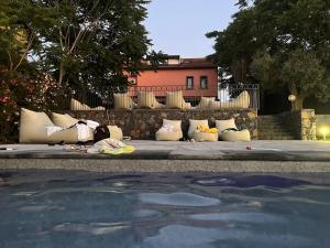 a group of pillows sitting on the ground near a pool at Ottomood B&B and Apartments in Tremestieri Etneo