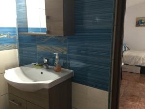 a bathroom with a white sink and a bed at Vila Roz in Mangalia +43 photos
