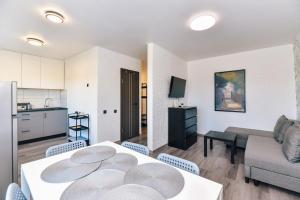 a kitchen and a living room with a table and chairs at King Petera in Ventspils