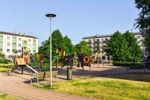 a park with a playground with a slide at King Petera in Ventspils