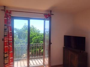 a living room with a sliding glass door to a balcony at Apartment Camelia in Opatija