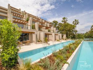 an exterior view of a villa with a swimming pool at Dreams Corfu Resort & Spa - All Inclusive in Gouvia