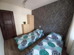 Posteľ alebo postele v izbe v ubytovaní Apartament na Podwalu