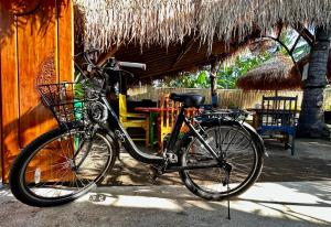 a bike parked in front of a building at Gili Land in Gili Air
